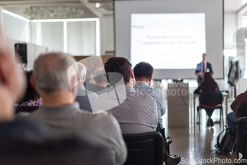 Image of Business speaker giving a talk at business conference event.