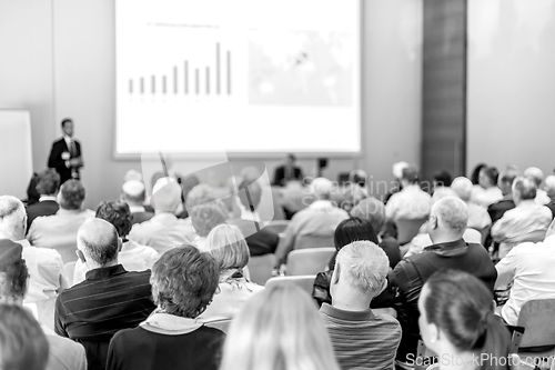 Image of Business speaker giving a talk in conference hall.