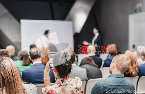 Image of Pitch presentation and project discussion at business convention or team meeting. Audience at the conference hall. Business and entrepreneurship symposium.