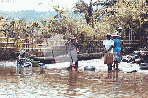 Image of Malagasy woman washes laundry, Madagascar countryside