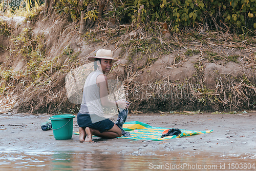 Image of Malagasy woman washes laundry, Madagascar countryside