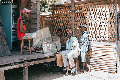 Image of Malagasy men repairing speakers, Maroantsetra Madagascar
