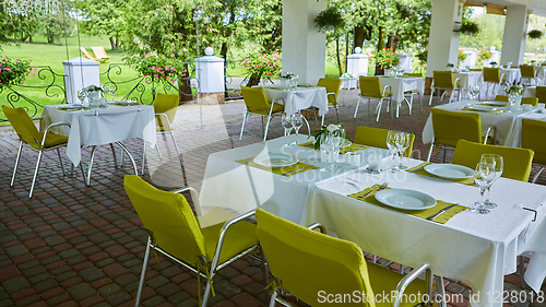 Image of terrace summer cafe with tables and chairs for people, an empty institution for recreation, nobody