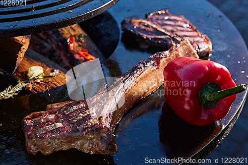 Image of beautifully seared tomahawk steak, medium rare to rare