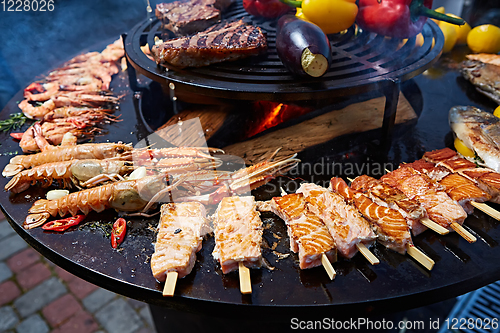 Image of Grilled fresh seafood: prawns, fish, octopus, oysters food background Barbecue Cooking BBQ