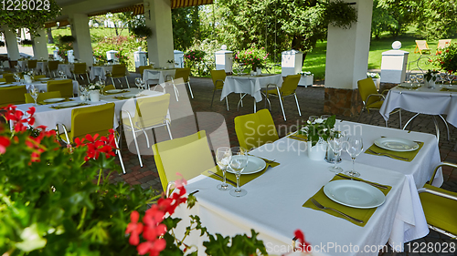 Image of terrace summer cafe with tables and chairs for people, an empty institution for recreation, nobody