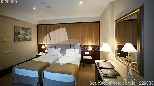 Image of Two beds in a hotel room. Interior design