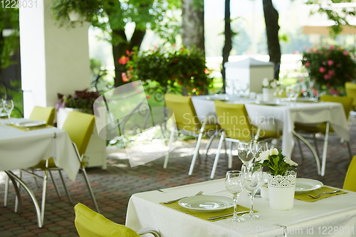 Image of terrace summer cafe with tables and chairs for people, an empty institution for recreation, nobody