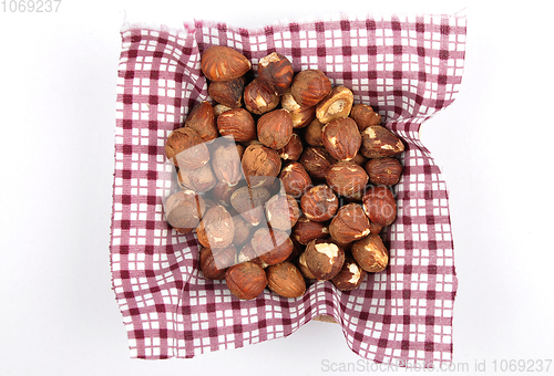 Image of Hazelnuts on cloth in bamboo bowl 