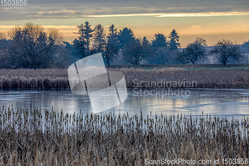 Image of rural landscape with frozen small pond