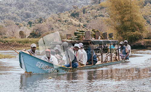 Image of overloaded boat taxi in countryside on river