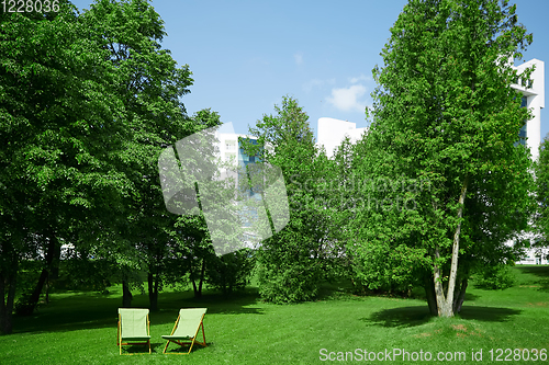 Image of Two resting chairs in the city park