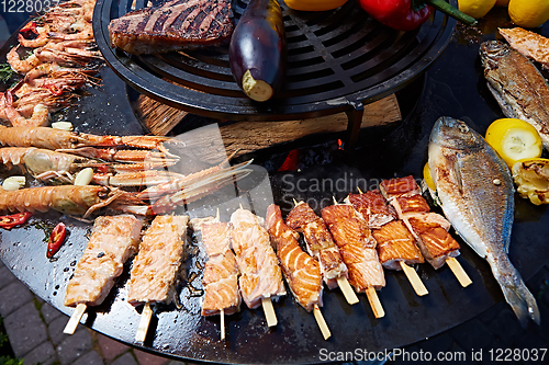 Image of Grilled fresh seafood: prawns, fish, octopus, oysters food background Barbecue Cooking BBQ