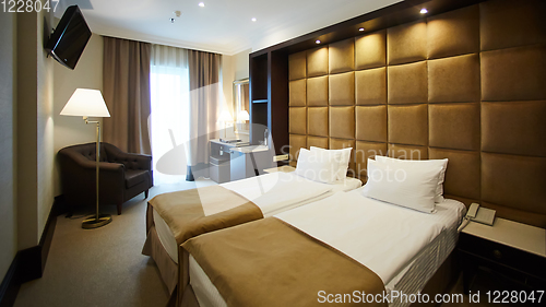 Image of Two beds in a hotel room. Interior design