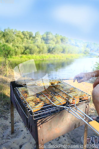 Image of man cooks barbecue from hen's meat 