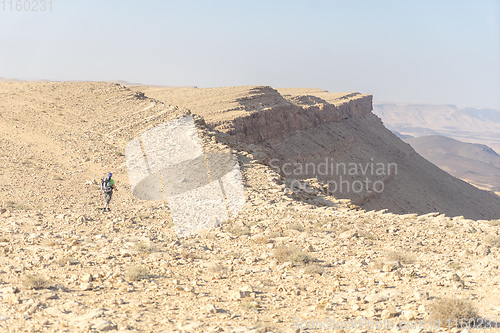 Image of Hiking tourist in desert trek adventure