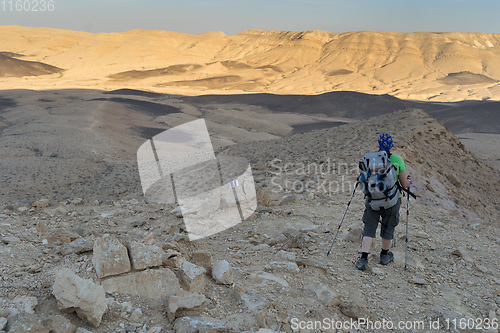 Image of Hiking tourist in desert trek adventure