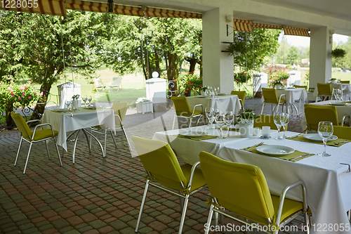 Image of terrace summer cafe with tables and chairs for people, an empty institution for recreation, nobody