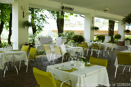 Image of terrace summer cafe with tables and chairs for people, an empty institution for recreation, nobody