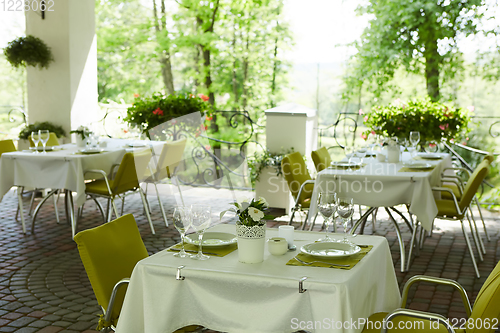 Image of terrace summer cafe with tables and chairs for people, an empty institution for recreation, nobody