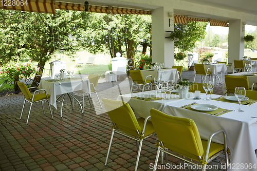 Image of terrace summer cafe with tables and chairs for people, an empty institution for recreation, nobody