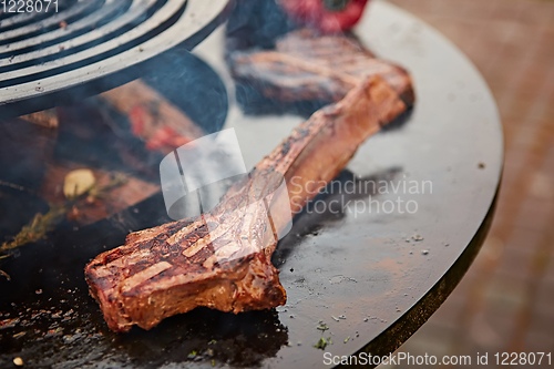 Image of beautifully seared tomahawk steak, medium rare to rare