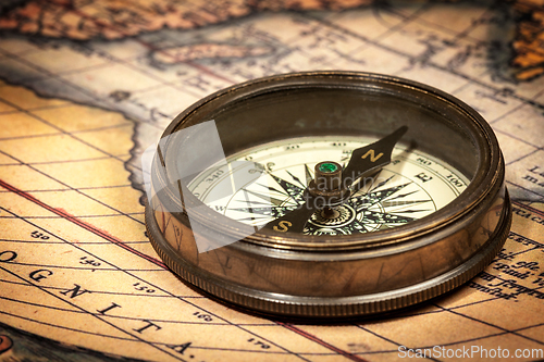 Image of Old vintage compass on ancient map