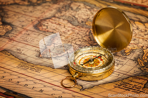 Image of Old vintage golden compass on ancient map