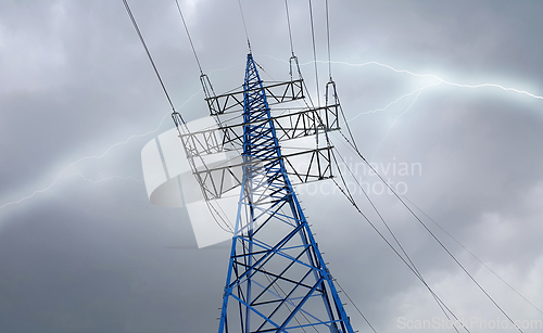 Image of High voltage tower against the cloudy sky with lightning strike