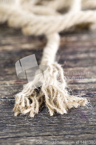 Image of broken and untangled thick linen rope