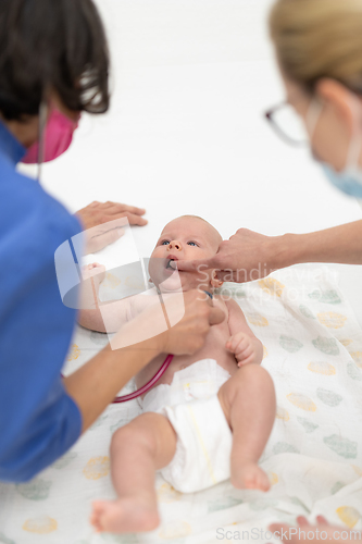 Image of Baby lying on his back as his doctor examines him during a standard medical checkup