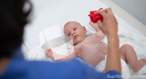 Image of Baby lying on his back as his doctor examines him during a standard medical checkup