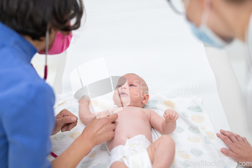 Image of Baby lying on his back as his doctor examines him during a standard medical checkup