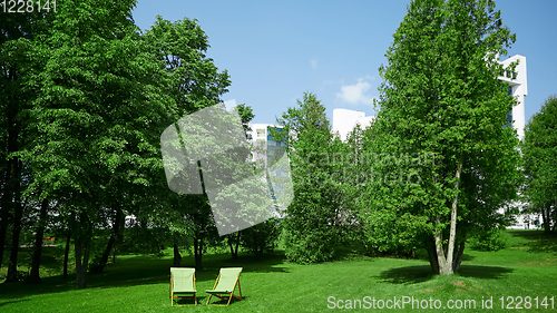 Image of Two resting chairs in the city park