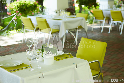 Image of terrace summer cafe with tables and chairs for people, an empty institution for recreation, nobody