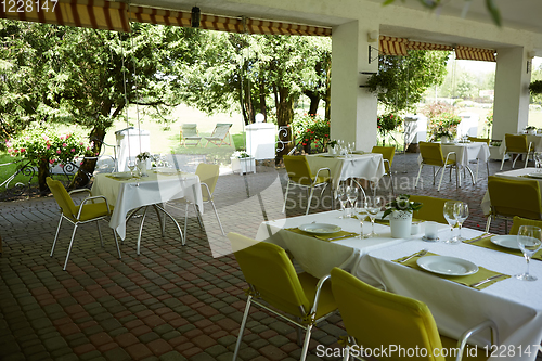 Image of terrace summer cafe with tables and chairs for people, an empty institution for recreation, nobody