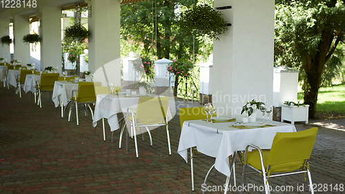 Image of terrace summer cafe with tables and chairs for people, an empty institution for recreation, nobody