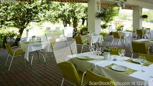 Image of terrace summer cafe with tables and chairs for people, an empty institution for recreation, nobody