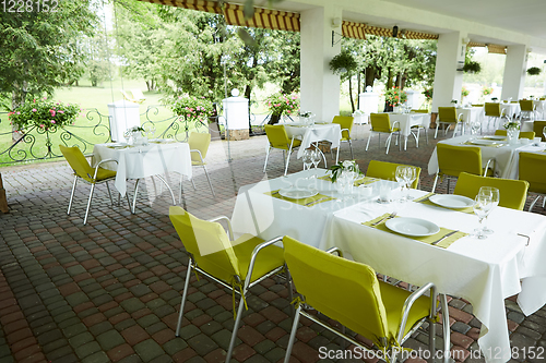 Image of terrace summer cafe with tables and chairs for people, an empty institution for recreation, nobody