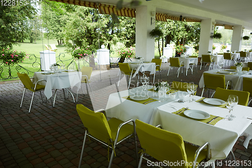 Image of terrace summer cafe with tables and chairs for people, an empty institution for recreation, nobody