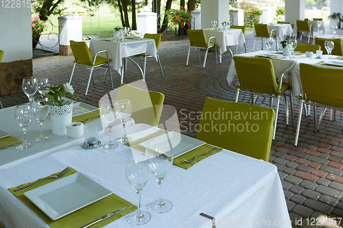 Image of terrace summer cafe with tables and chairs for people, an empty institution for recreation, nobody