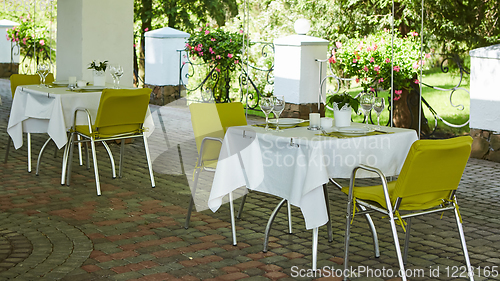 Image of terrace summer cafe with tables and chairs for people, an empty institution for recreation, nobody