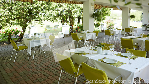 Image of terrace summer cafe with tables and chairs for people, an empty institution for recreation, nobody