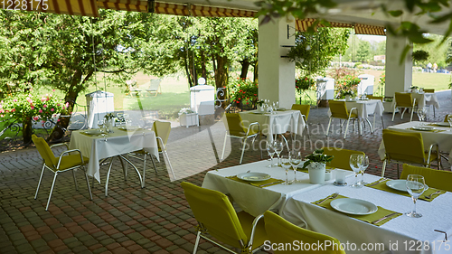 Image of terrace summer cafe with tables and chairs for people, an empty institution for recreation, nobody