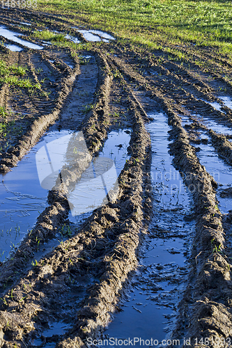 Image of deep ruts on black soil