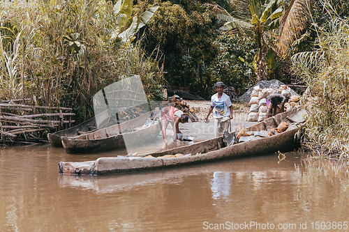 Image of Malagasy woman washes dishes, Madagascar countryside