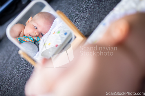 Image of Beautiful shot of mirror reflectiona of cute baby boy playing with toys.