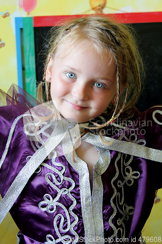 Image of little blue-eyed girl in an Moroccan suit