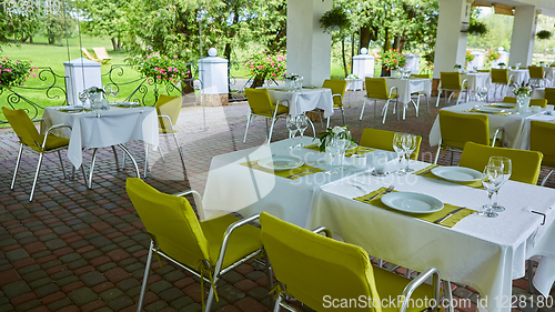 Image of terrace summer cafe with tables and chairs for people, an empty institution for recreation, nobody