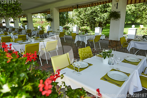 Image of terrace summer cafe with tables and chairs for people, an empty institution for recreation, nobody